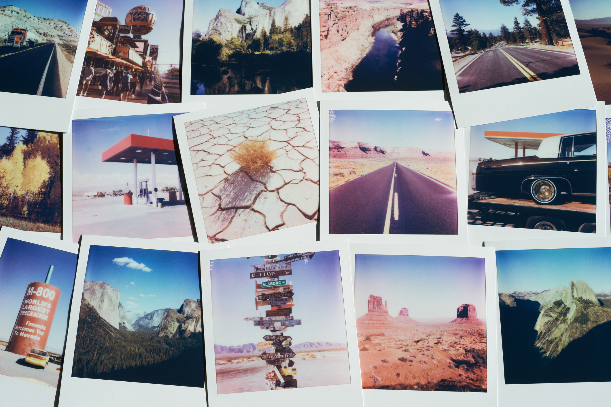 USA, Collection of instant film photos from a road trip displayed on a table
