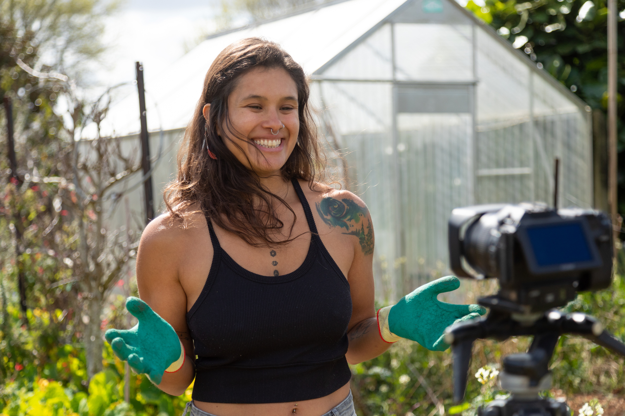 A woman vlogging in her vegetable garden