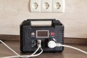 Portable Power Station and Multi-socket Extension Board with Chargers on table indoors