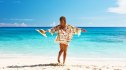 Woman with sarong on beach Anse Intendance at Seychelles, Mahe