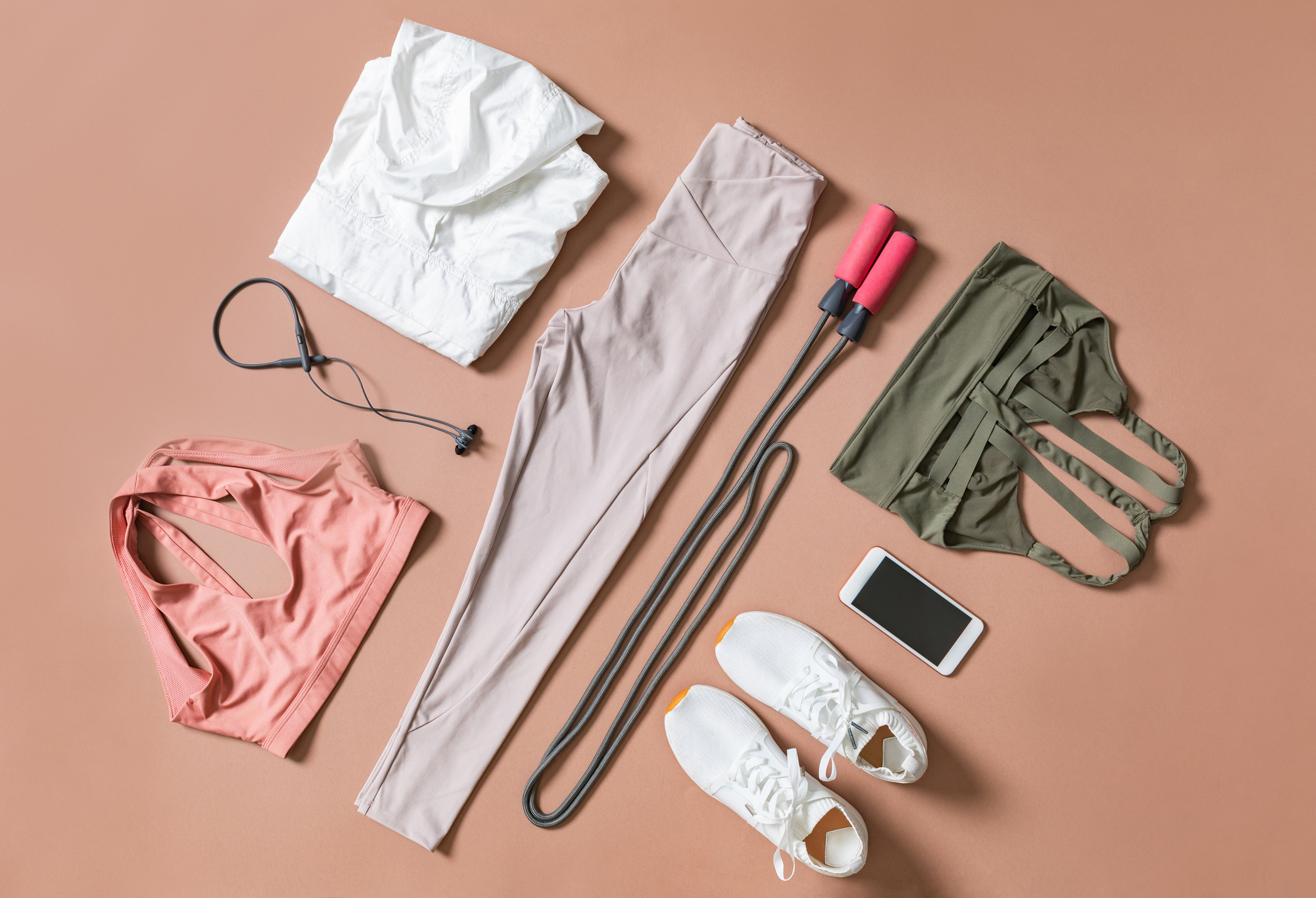 From above photo of composition of woman's sportswear and training equipment.