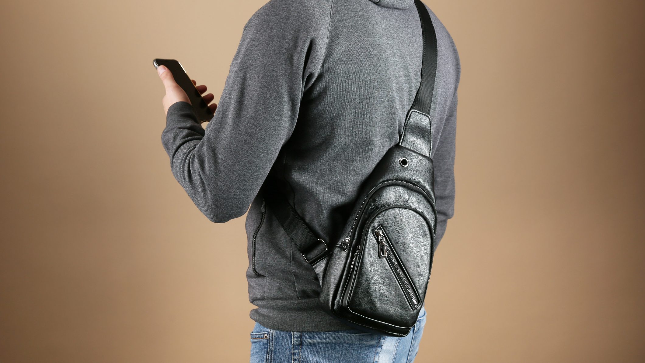 men's leather sling bag is on person close up