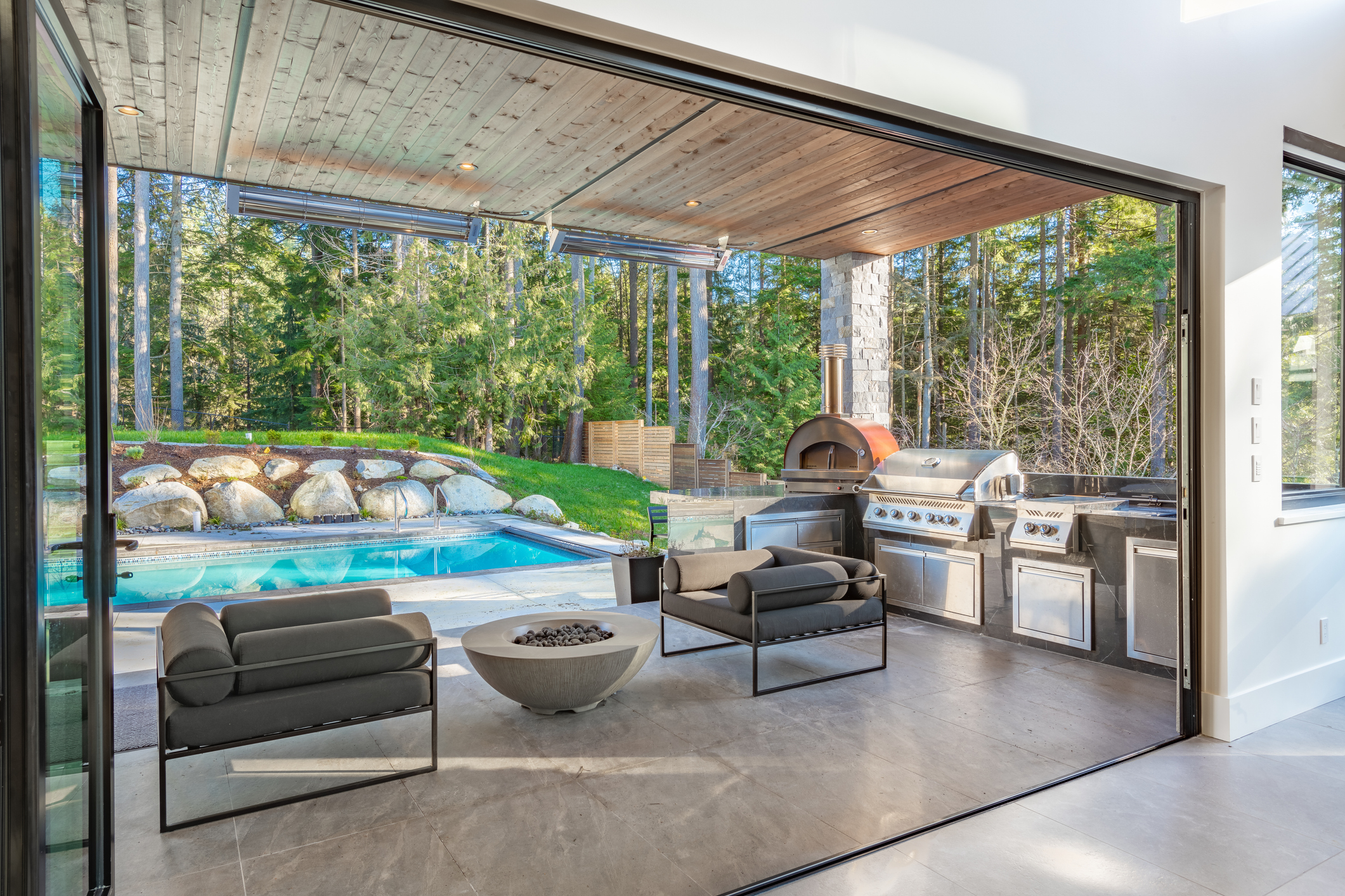 A very large modern contemporary private residence residential home spacious interiors living room, kitchen, office, recreation room, foyer, hallway, floating staircase window wall open to a patio with BBQ and swimming pool. New construction family home