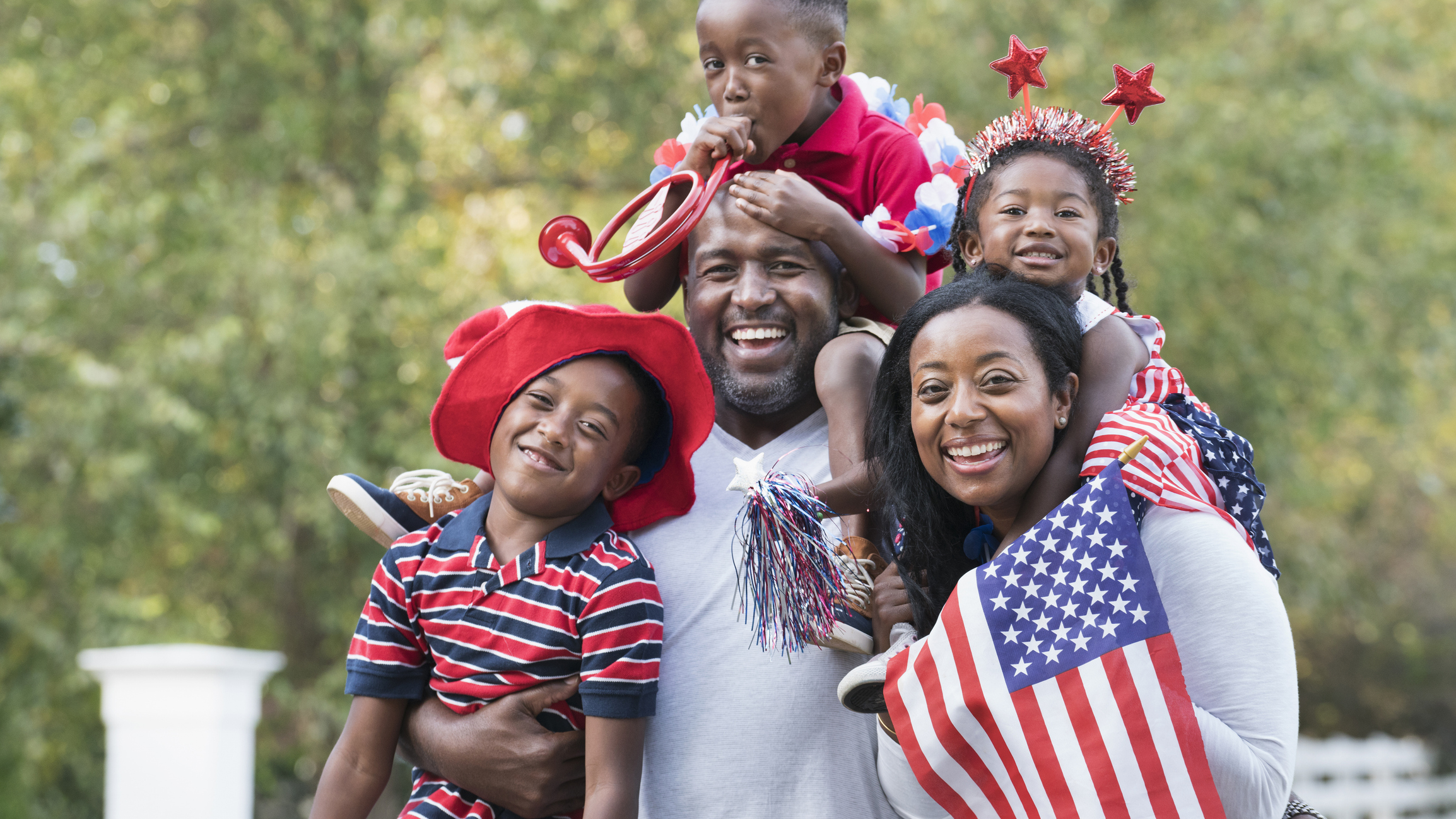 Portrait of Black family celebrating 4th of July in park