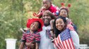 Portrait of Black family celebrating 4th of July in park