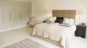 Interior of off-white modern bedroom