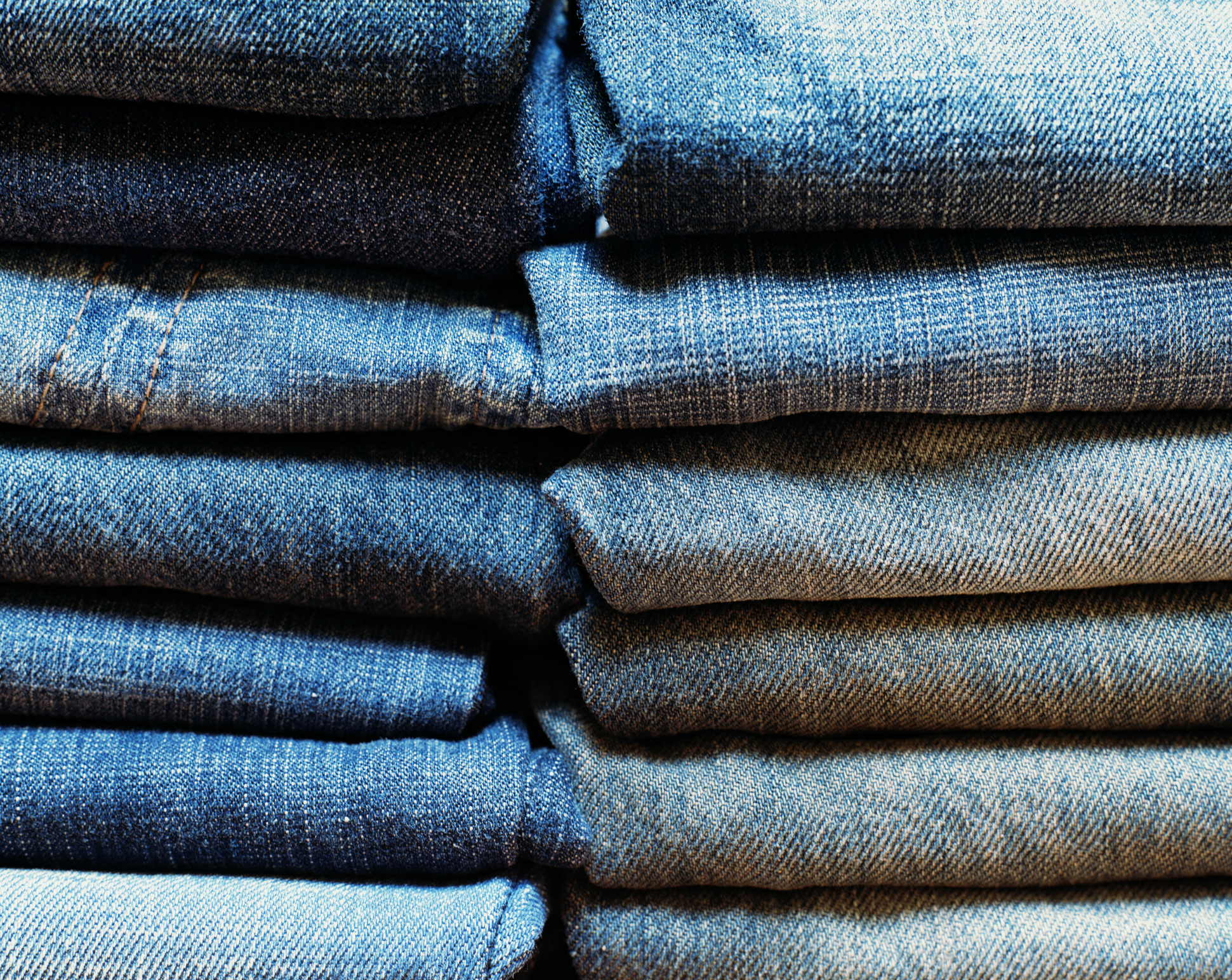 Stacks of denim pants, close-up