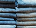 Stacks of denim pants, close-up