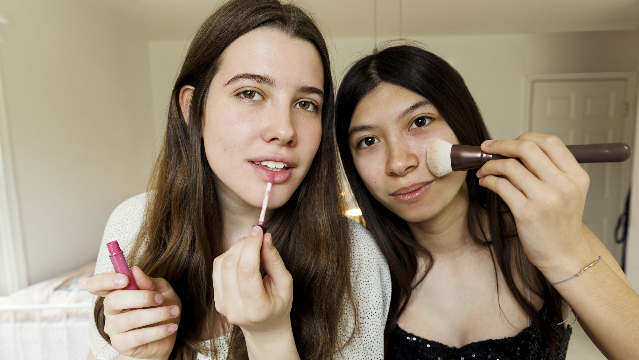 girls applying make-up while getting ready for party