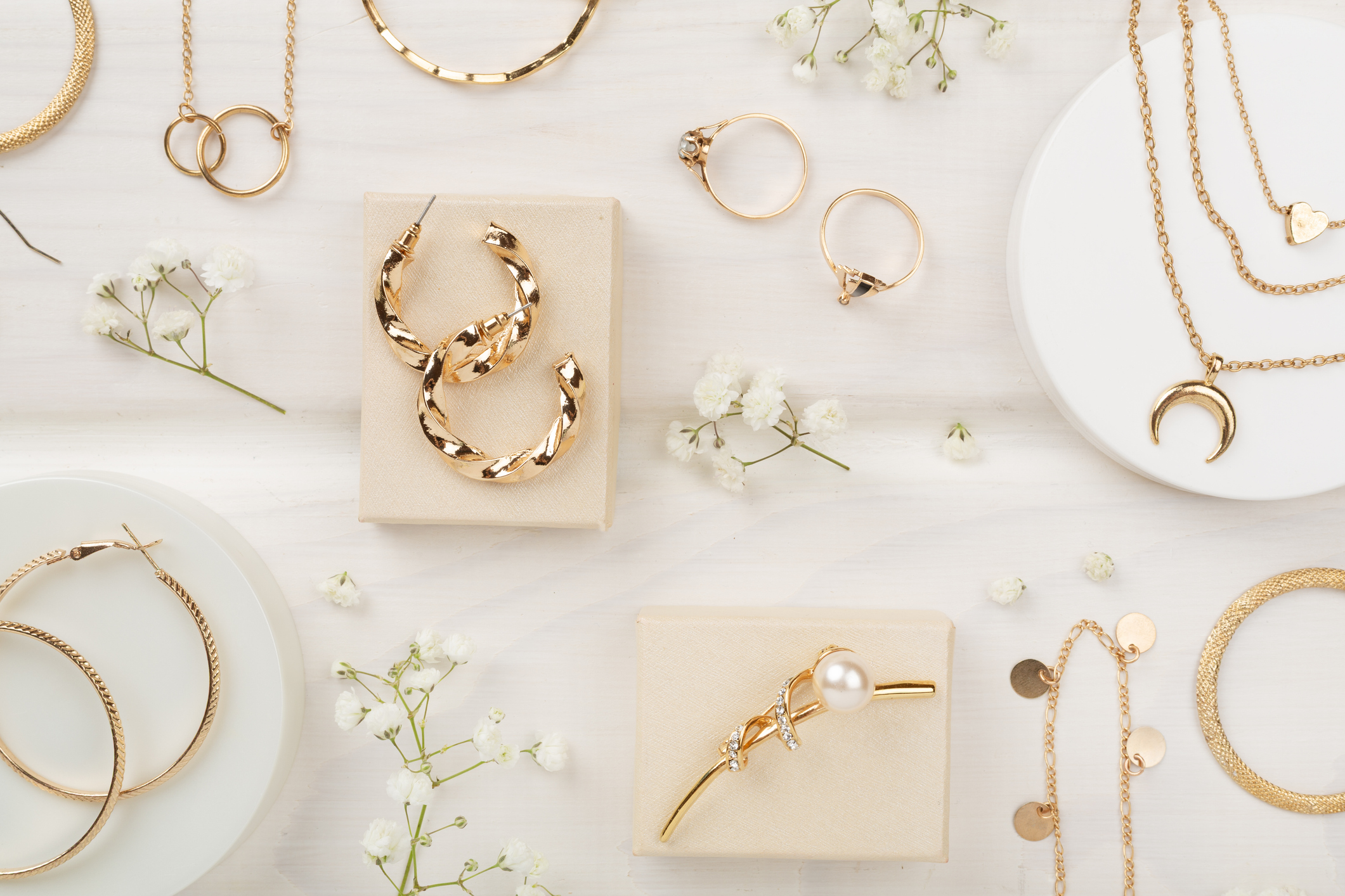 Elegant golden jewelry with decoration on wooden background, top view