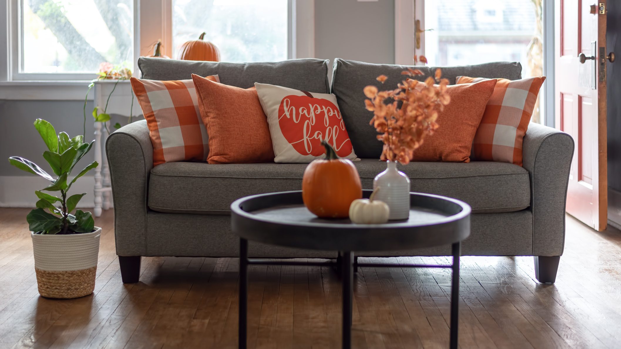 Happy fall throw pillow on the sofa for autumn season home decor
