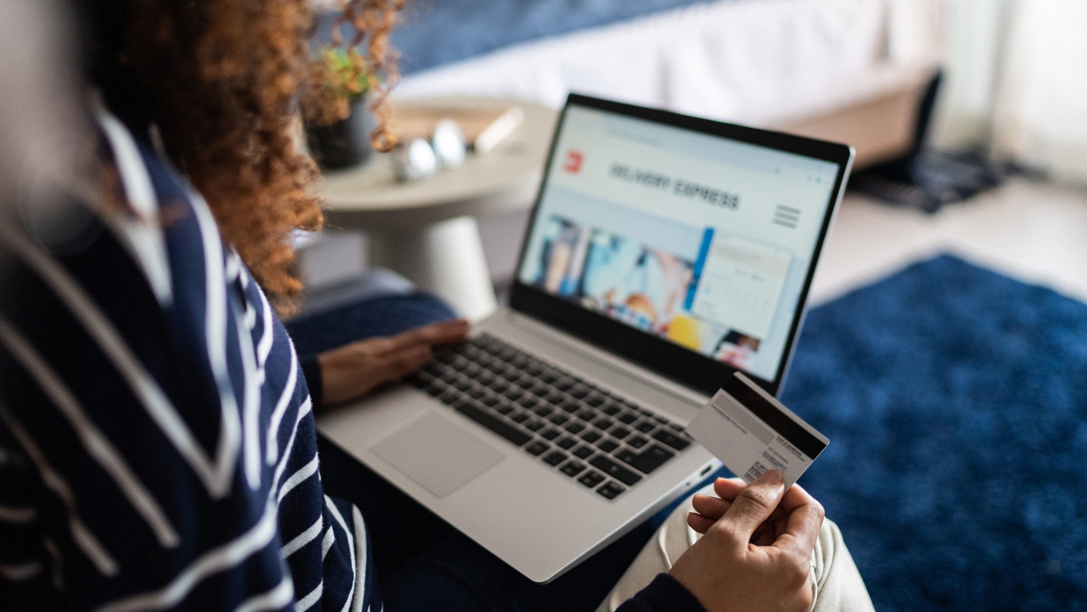Young woman online shopping using the laptop at home
