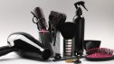 Different hairdresser's tools on light grey background, closeup