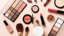 Make up products. Shadow palette with brushes, lipstick, cream and others. Flat lay on pink background.
