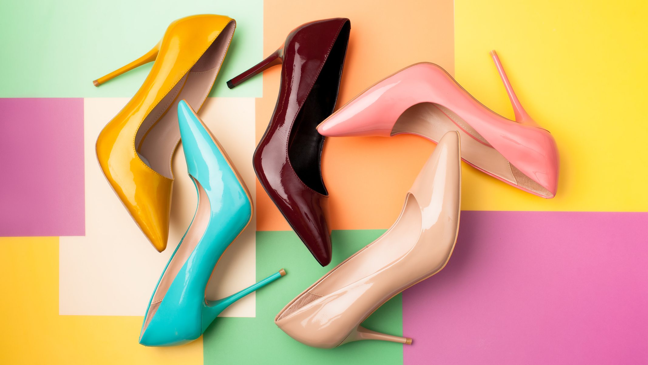 Bright colored women's shoes on a solid background. Copy space text.