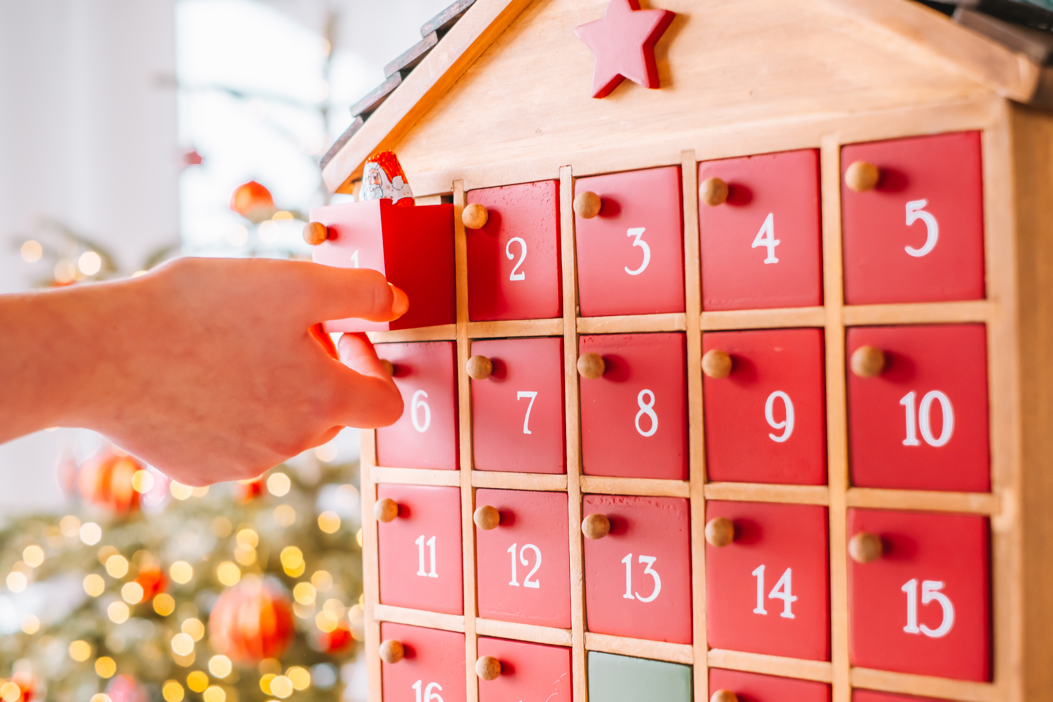 Advent Calendar .Red Wooden Advent Calendar With Santa Figurines. Hand Opening Wooden Christmas Advent Calendar Drawer.advent christmas surprise